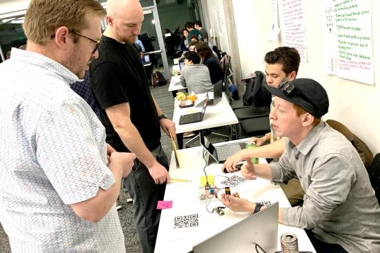 A team of students answering questions from two competition judges in a previous Seawolf Makeathon Competition at Sonoma State