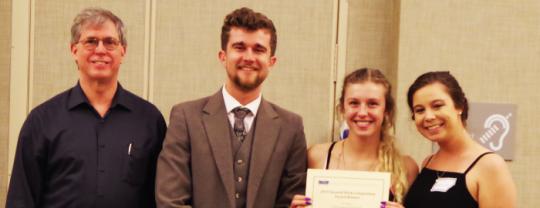 SSU Entrepreneurship Director Chris Stewart poses with a team of three students after they won an award at the Seawolf Pitch Competition