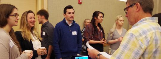 A team of students answering questions from a competition judge in a previous Seawolf Pitch Competition at Sonoma State